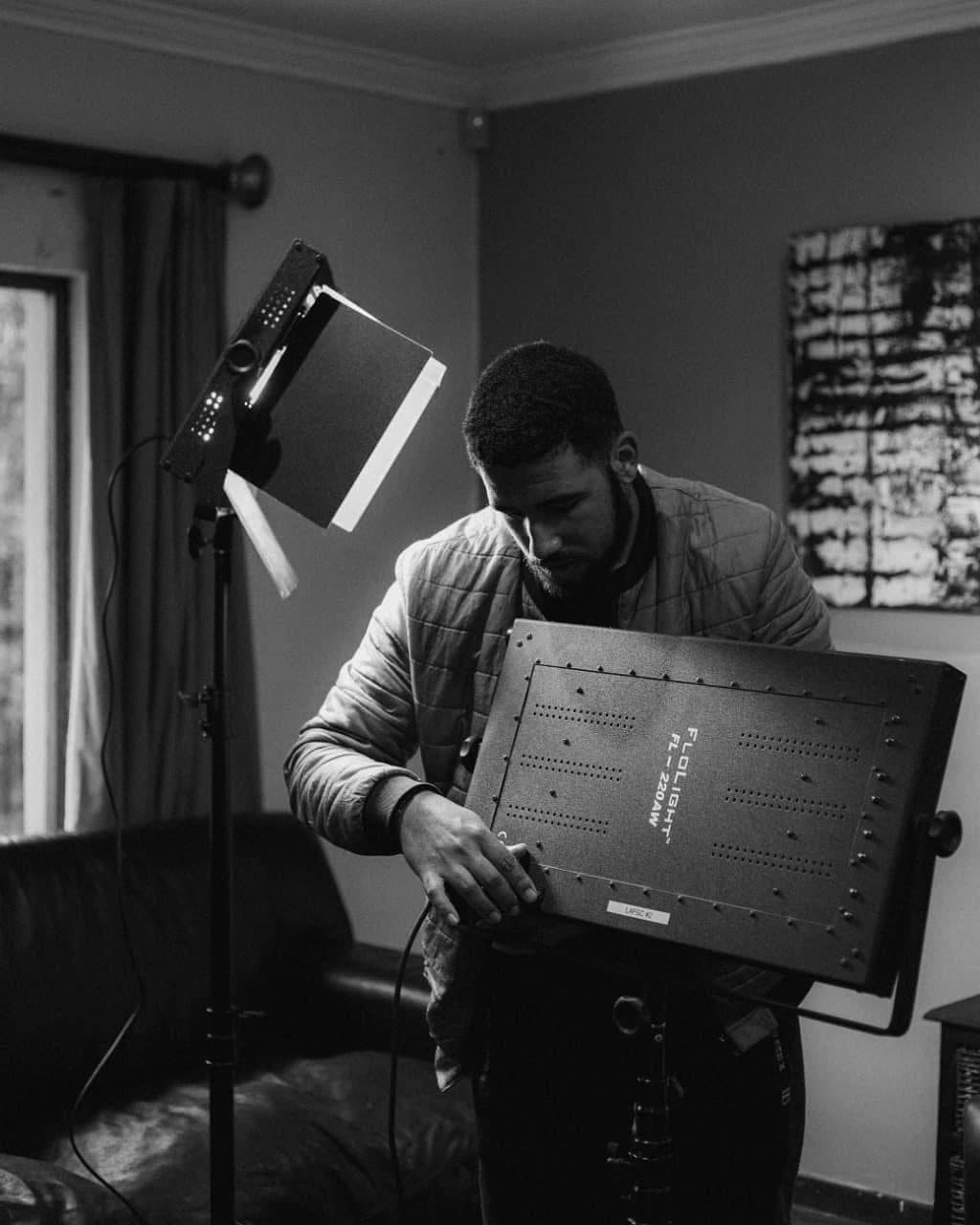 Aron setting up lighting on a production